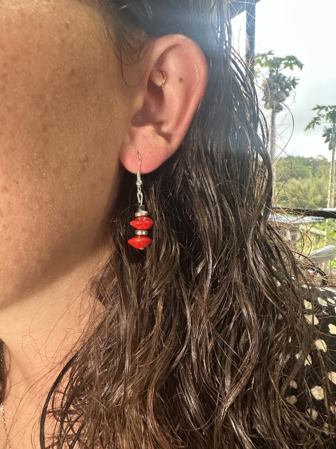 lady modelling red sandalwood earrings