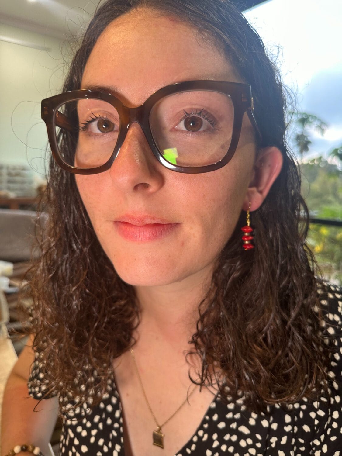 lady modelling earrings with Red Sandalwood beads