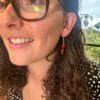 lady modelling red sandalwood earrings