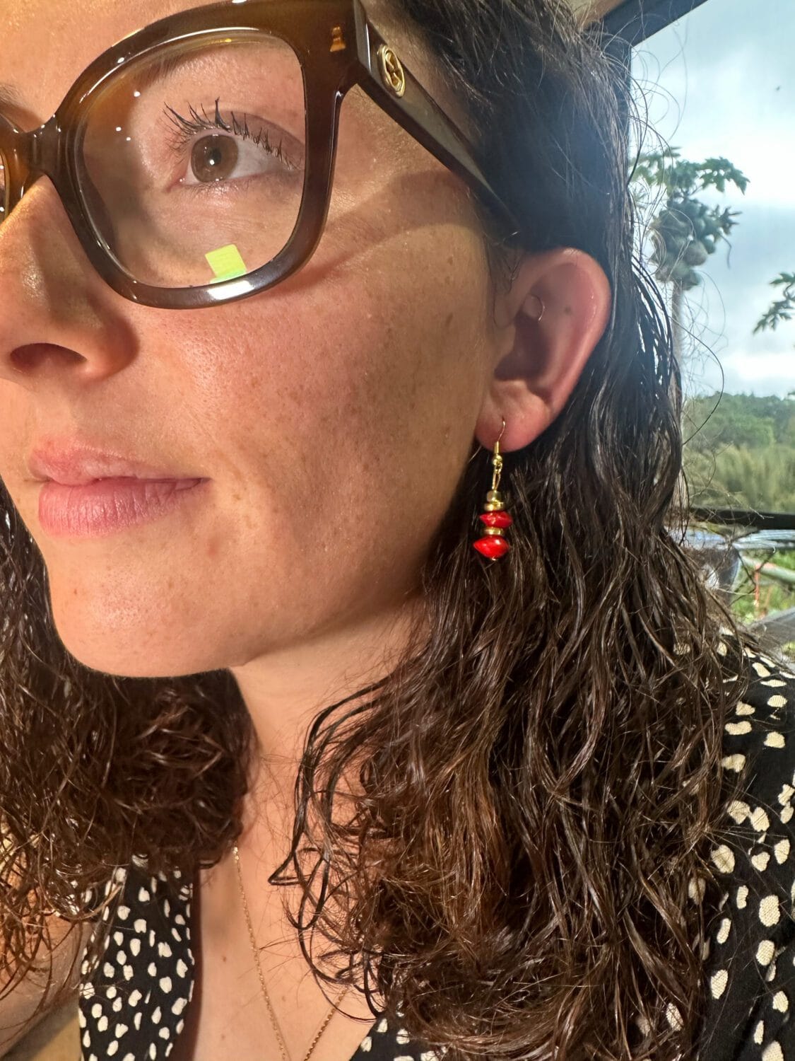 lady modelling earrings with Red Sandalwood beads