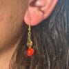 lady modelling earrings with Red Sandalwood beads