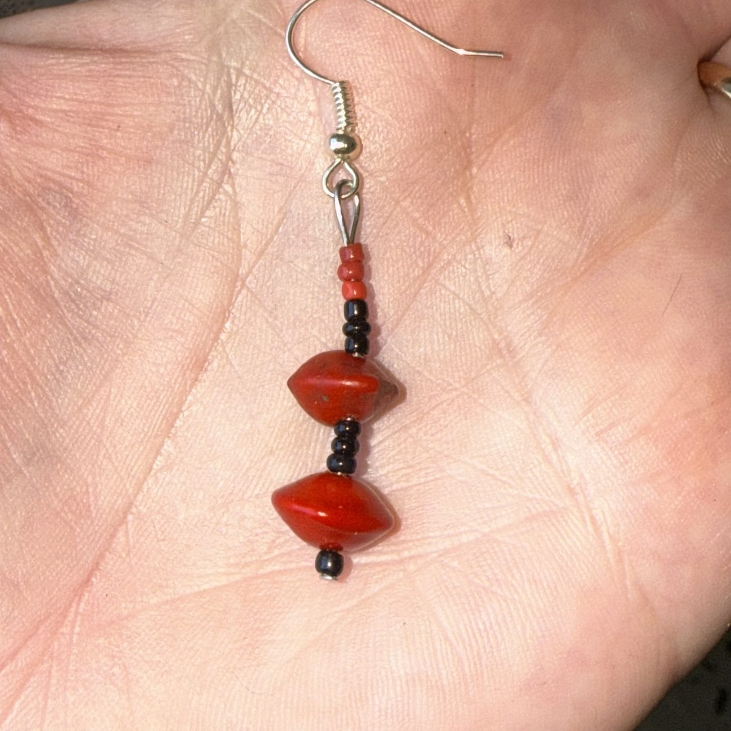 Red sandalwood seed and black glass earrings