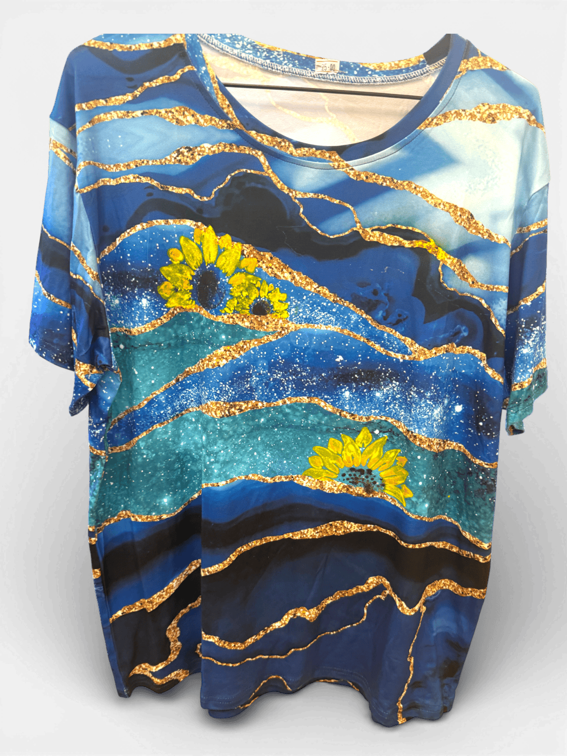 IMG_8029 8 Blue patterned blouse with golden wavy lines and yellow sunflowers on a gradient blue background.