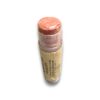 lip - OPT Peach-pink lipstick portion exposed from a cork-wrapped tube against a white background